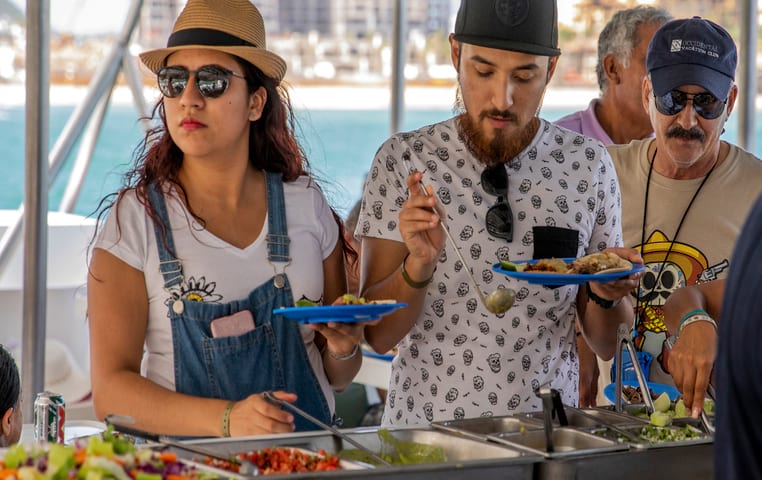 People eating from delicious Buffet on catamaran
